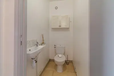 a bedroom with a bed and a tv and a chair at Ultra Central 2 Bdr - AC & Balcony in Nice
