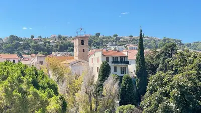 a building on the side of a hill with trees at Jolie studio - 2 personnes - Saint laurent du Var in Saint-Laurent-du-Var