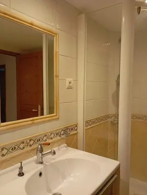 a bathroom with a sink and a mirror and a shower at Bas de villa , coin détente extérieur et parking in Cagnes-sur-Mer