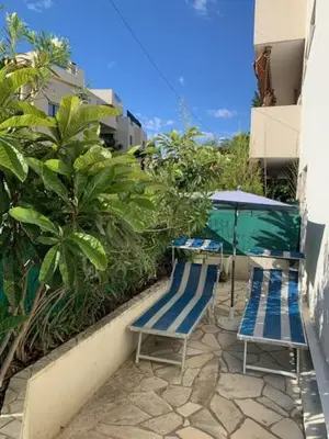 two blue benches sitting on a patio with plants at Studio NICE near the sea in Nice