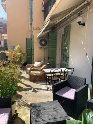 an outdoor patio with chairs and tables and chairs at Appartement et terrasse Nice centre in Nice
