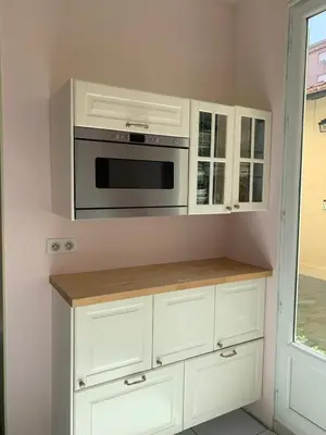 a kitchen with white cabinets and a microwave at Appartement et terrasse Nice centre in Nice