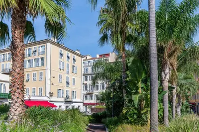 a group of palm trees and a building at 