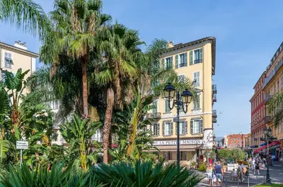 a street with palm trees and buildings in a city at 