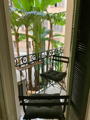 two chairs sitting on a balcony with palm trees at Perfectly located 1 bed apartment - Port of Nice in Nice