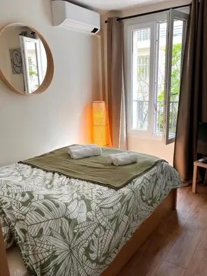 a bedroom with a bed and a mirror at Bottero nice in Nice