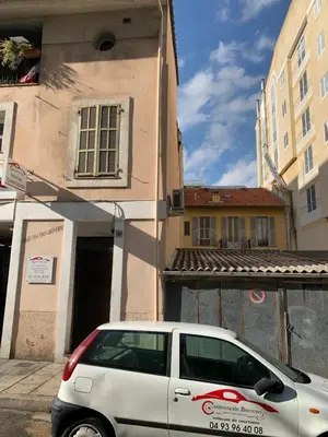 a white car parked in front of a building at Bottero nice in Nice