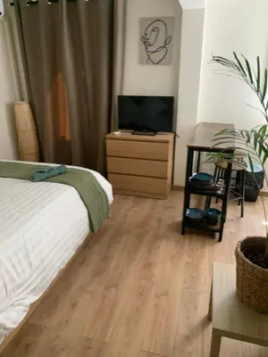 a bedroom with a bed and a dresser with a television at Bottero nice in Nice