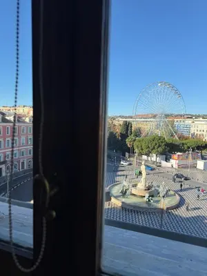 a view from a window of a ferris wheel at Studio Place Masséna Vieux Nice - situation idéale in Nice