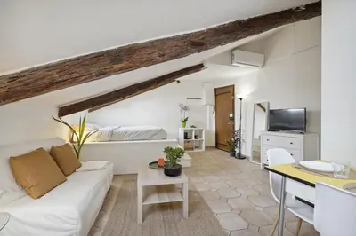a living room with a white couch and a table at Studio Place Masséna Vieux Nice - situation idéale in Nice