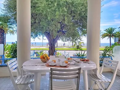 a white table with fruit on it on a patio at Promenade des Anglais GARDEN SEA VIEW in Nice