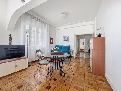 a bedroom with a bed in the middle of a room at Promenade des Anglais GARDEN SEA VIEW in Nice