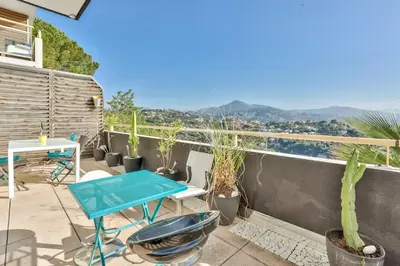 a patio with a table and chairs on a balcony at Heidi Braesch Apartment in Nice