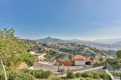a view of a city with mountains in the background at Heidi Braesch Apartment in Nice