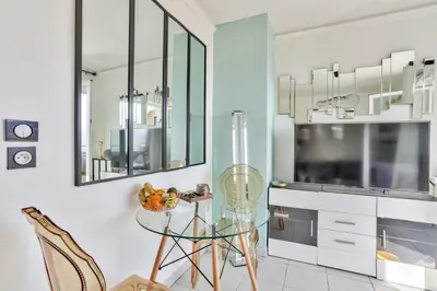 a kitchen with a glass table and some chairs at Heidi Braesch Apartment in Nice