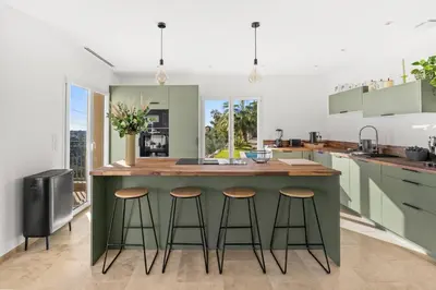 a kitchen with a large island with bar stools at Happyfew Domaine des Sources in Nice