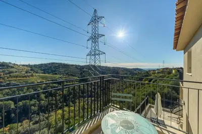 a balcony with a view of a mountain at Happyfew Domaine des Sources in Nice