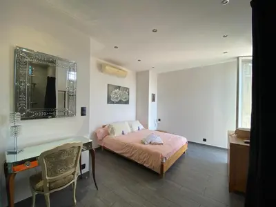 a bedroom with a bed and a desk and a mirror at Beautiful 2 rooms 45 m2 Nice in Nice