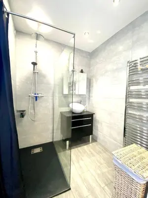 a bathroom with a glass shower with a sink at Beautiful 2 rooms 45 m2 Nice in Nice