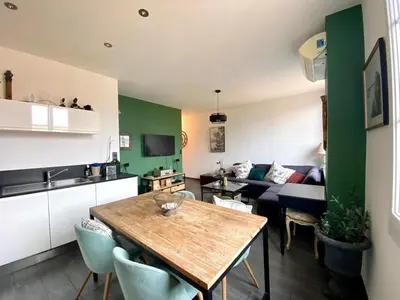 a kitchen and living room with a table and a couch at Beautiful 2 rooms 45 m2 Nice in Nice