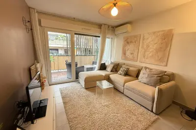 a living room with a couch and a table at Cozy apartment in the heart of Nice in Nice
