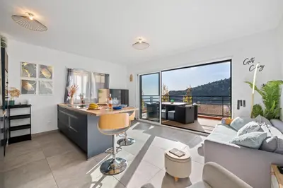an apartment with a kitchen and a living room at Modern Luxury - Sea View over Èze Village in Èze