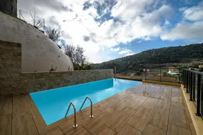 a swimming pool on the side of a house at Modern Luxury - Sea View over Èze Village in Èze