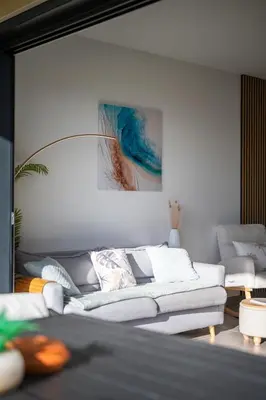 a living room with a white couch and a painting at Modern Luxury - Sea View over Èze Village in Èze