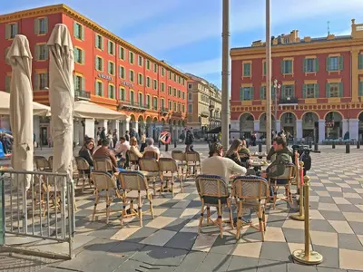 a group of people sitting at tables in a street at Plein centre, calme et cosy in Nice