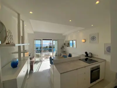 a kitchen and living room with a view of the ocean at mure in Beaulieu-sur-Mer