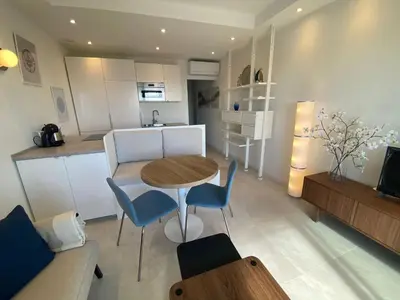 a kitchen and living room with a table and chairs at mure in Beaulieu-sur-Mer
