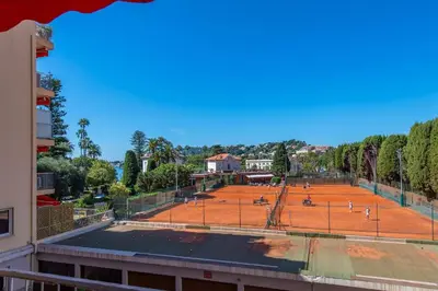 a tennis court in front of a building at fisher in Beaulieu-sur-Mer
