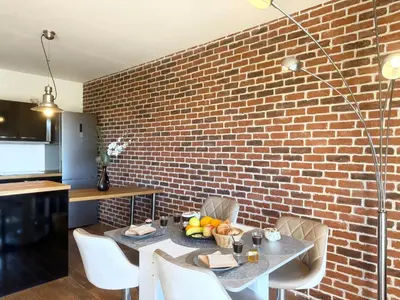 a brick wall with a table with fruit on it at 2 pièces cosy avec grande terrasse & piscine in Cagnes-sur-Mer