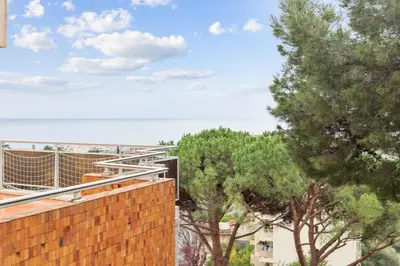 an arched window in a living room with a couch at LX173 Studio grande terrasse vue mer tres calme in Nice
