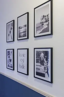 a row of framed pictures on a wall at Chambre 4 La Nissa Bella in Nice