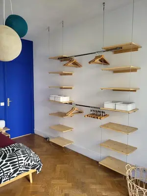 a room with wooden shelves on the wall at 2P cosy avec terrasse, vue mer & plages à pied in Nice