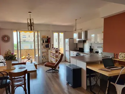 a kitchen with a table with a laptop on it at 2P cosy avec terrasse, vue mer & plages à pied in Nice