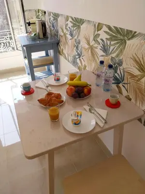 a table with two plates of food on it at Spacious apartment with balcony - Nice center in Nice