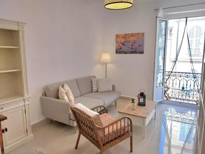 a living room with a couch and a table at Spacious apartment with balcony - Nice center in Nice