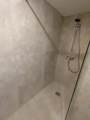 a shower with a glass door in a bathroom at Gite Maïoun Cremat in Nice