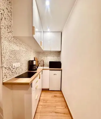 a small kitchen with white cabinets and a sink at Cozy apartment in the heart of Nice - 3 to 4 people in Nice