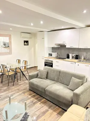 a living room with a couch and a table at T2 cosy et climatise Vieux Nice Garibaldi in Nice