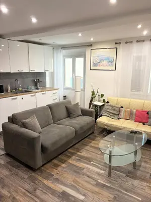 a living room with a couch and a glass table at T2 cosy et climatise Vieux Nice Garibaldi in Nice