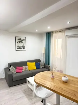 a living room with a couch and a table at Elegant T2 Climatise Vieux Nice Garibaldi in Nice