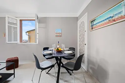 a dining room with a black table and chairs at Casa Nissa Vieux-Nice in Nice