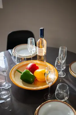 a plate of food on a table with a bottle of wine at Casa Nissa Vieux-Nice in Nice
