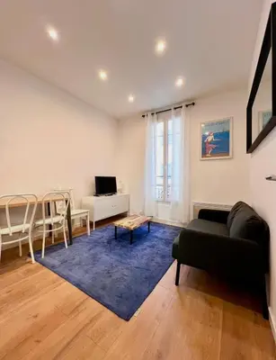 a living room with a couch and a table at Beaumont Résidence in Nice