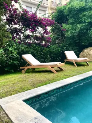 two lounge chairs next to a swimming pool at Luxury villa with Pool and Garden perfect location in Beaulieu-sur-Mer