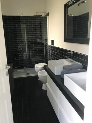 a black and white bathroom with two sinks and a toilet at Luxury villa with Pool and Garden perfect location in Beaulieu-sur-Mer