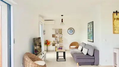 a living room with a couch and a table at La Vista Mar - Apt Seaview Near Airport-AC-Parking in Saint-Laurent-du-Var
